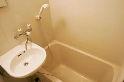 a bathroom with a sink and a toilet and a tub at Hotel Peace (Adult Only) in Tokyo