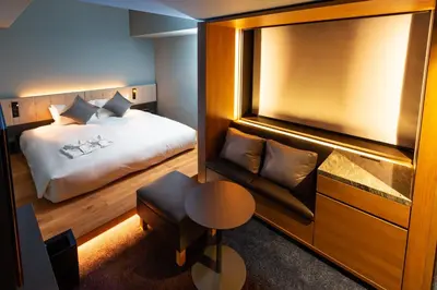 a hotel room with a bed and a couch at The Royal Park Canvas - Ginza 8 in Tokyo