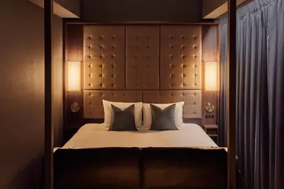 a bedroom with a bed with two pillows at The Royal Park Canvas - Ginza 8 in Tokyo
