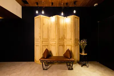 a wooden wall with a bench in a room at The Royal Park Canvas - Ginza 8 in Tokyo