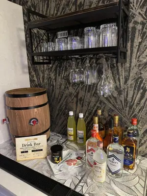 a shelf with bottles of alcohol and a barrel at HOTEL EXE (Adult Only) in Tokyo