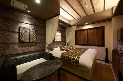 a hotel room with a bed and a couch at HOTEL EXE (Adult Only) in Tokyo