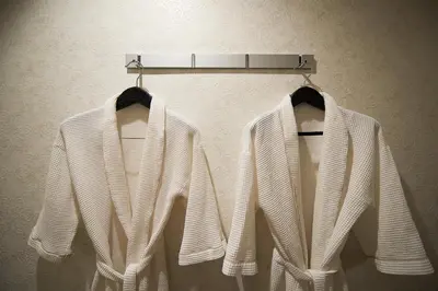 two white sweaters are hanging on a rack at HOTEL EXE (Adult Only) in Tokyo