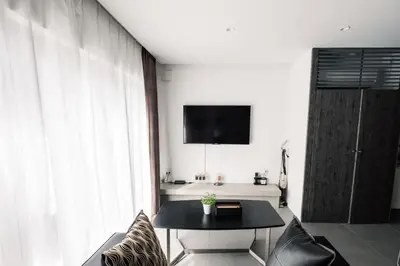 a living room with a table and a tv at SPATIUM GINZA in Tokyo