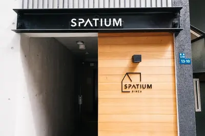 a sign on the door of a building at SPATIUM GINZA in Tokyo