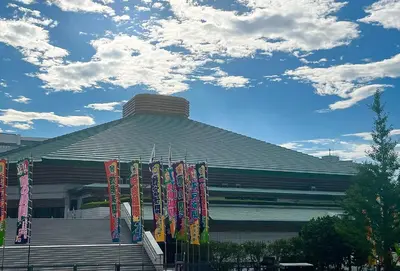 a building with colorful flags in front of it at HOTEL AMANEK Asakusa Ekimae in Tokyo