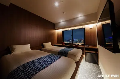 a hotel room with two beds and a window at HOTEL AMANEK Asakusa Ekimae in Tokyo