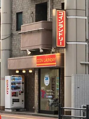 a store with a sign on the side of a building at Hatoya Hotel in Tokyo