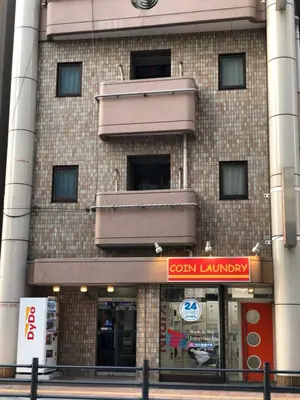 a building with a store on the side of it at Hatoya Hotel in Tokyo
