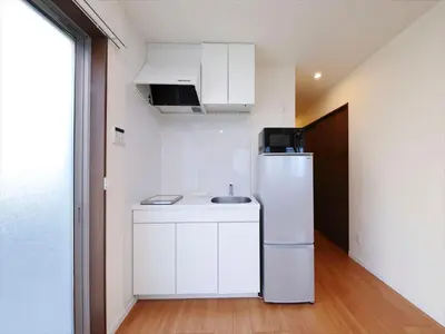a small kitchen with a refrigerator and a sink at COTO Tokyo Shibuya 4 in Tokyo