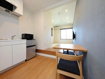 a room with a table and a kitchen with a counter at COTO Tokyo Shibuya 4 in Tokyo