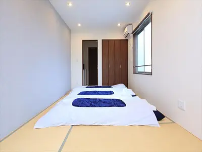 two beds in a bedroom with a window at COTO Tokyo Shibuya 4 in Tokyo