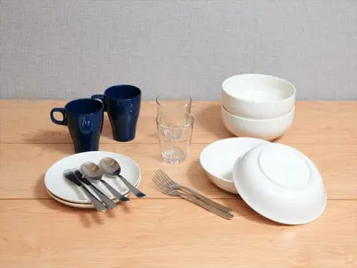 a table with white plates and utensils on it at COTO Tokyo Shibuya 4 in Tokyo