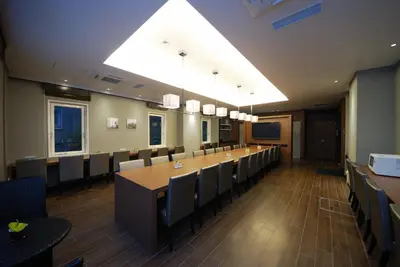 a conference room with a long table and chairs at Sotetsu Fresa Inn Hamamatsucho-Daimon in Tokyo