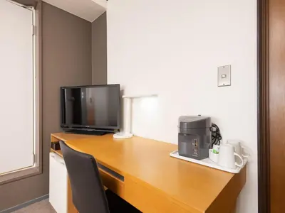 a desk with a television and a coffee maker on it at Tabist Hotel New Washington Shibuya in Tokyo