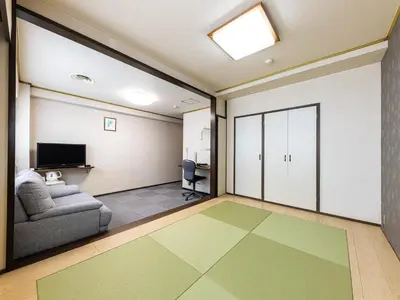 a living room with a couch and a television at Tabist Hotel New Washington Shibuya in Tokyo
