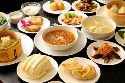 a bunch of plates of food on a table at Tabist Hotel New Washington Shibuya in Tokyo