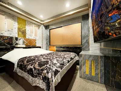 a bedroom with a bed and a large window at Hotel Rocks in Tokyo