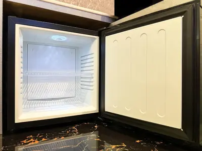an empty refrigerator with its door open on a counter at Hotel Rocks in Tokyo