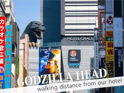 a sign for a hotel with a dinosaur on a building at Hotel Rocks in Tokyo