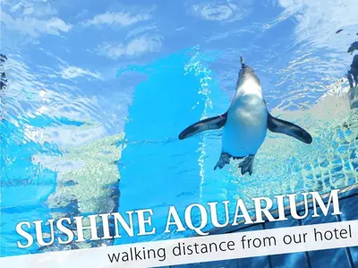 a penguin swimming in the water in an aquarium at Ikebukuro Central Hotel in Tokyo