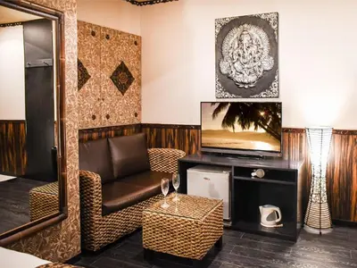 a living room with a chair and a television at Ikebukuro Grand Hotel in Tokyo