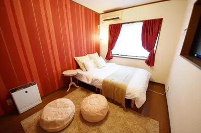 a small bedroom with a bed and a window at The Nest Ikebukuro House in Tokyo
