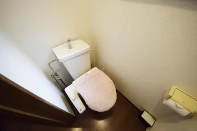 a small bathroom with a toilet and a sink at The Nest Ikebukuro House in Tokyo