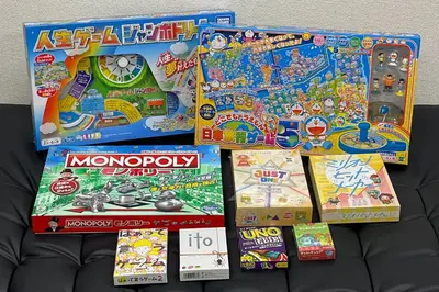 a pile of monopoly board games and other games at KandoStay \u6d45\u8349EAST\u30c6\u30e9\u30b9 in Tokyo
