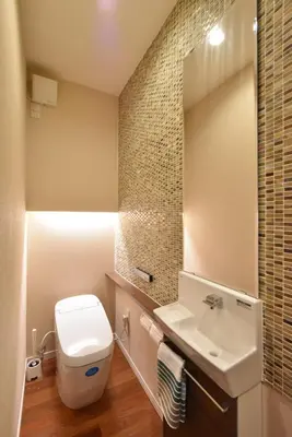 a bathroom with a toilet and a sink and a mirror at KandoStay \u6d45\u8349EAST\u30c6\u30e9\u30b9 in Tokyo