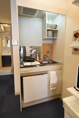 a small kitchen with a sink and a stove at KandoStay EAST TORANOMON in Tokyo