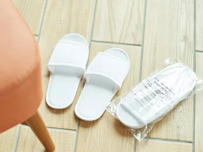 a pair of white shoes sitting on the floor at Sotetsu Fresa Inn Tokyo-Kyobashi in Tokyo
