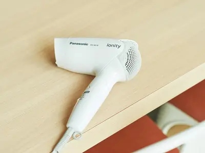 a hair dryer sitting on top of a table at Sotetsu Fresa Inn Tokyo-Kyobashi in Tokyo