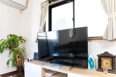 a large flat screen tv sitting on top of a table at Tokyo Aoto House in Tokyo