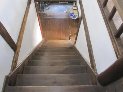 a flight of stairs in a building with a stair case at Taito Ryokan in Tokyo