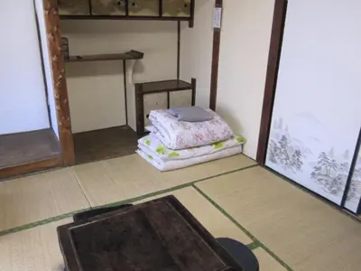 a room with a bed sitting on the floor at Taito Ryokan in Tokyo