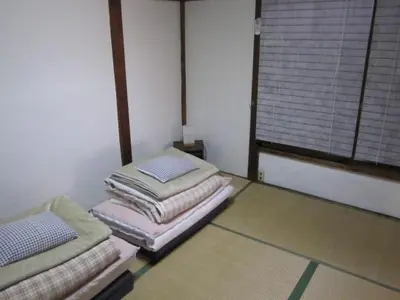 a room with three piles of towels on the floor at Taito Ryokan in Tokyo
