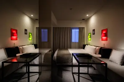 a hotel room with a bed and two tables and a couch at Shibuya Granbell Hotel in Tokyo