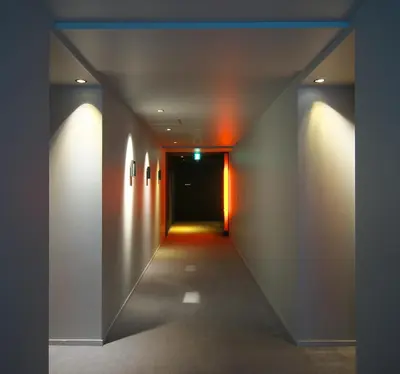 a hallway with a door and lights on the wall at Shibuya Granbell Hotel in Tokyo