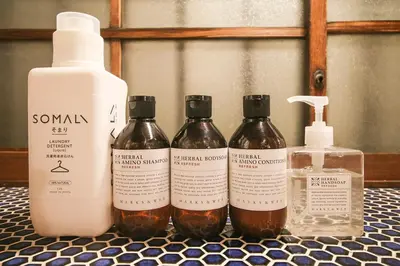 a group of four bottles of soap on a counter at TOKYO LITTLE HOUSE in Tokyo