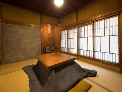 a room with a table in a room with windows at TOKYO LITTLE HOUSE in Tokyo