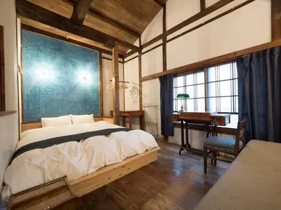 a bedroom with a bed and a desk and a table at TOKYO LITTLE HOUSE in Tokyo