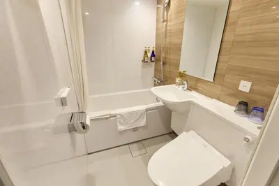 a bathroom with a toilet and a sink and a shower at Ginza International Hotel in Tokyo