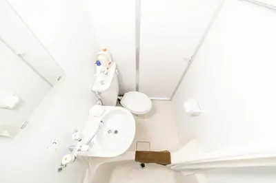 a white bathroom with a sink and a toilet at Maison de Takinogawa in Tokyo