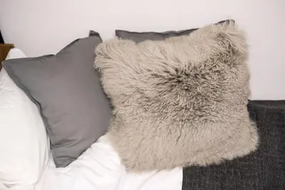 a furry pillow sitting on top of a couch at Maison de Takinogawa in Tokyo