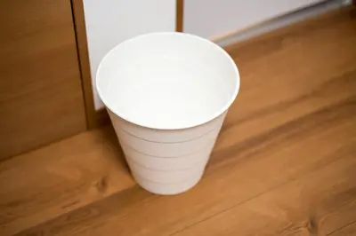 a white cup sitting on top of a wooden floor at Maison de Takinogawa in Tokyo