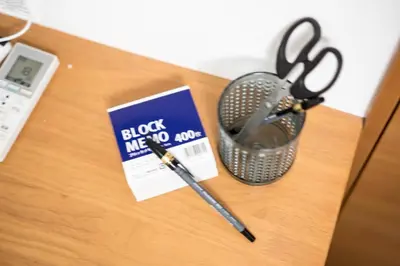a pair of scissors and a book on a table at Maison de Takinogawa in Tokyo