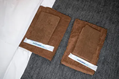 two brown napkins sitting on top of a floor at Maison de Takinogawa in Tokyo