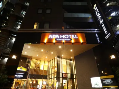 a building with an acar hotel sign on it at night at APA Hotel Kanda Ekihigashi in Tokyo