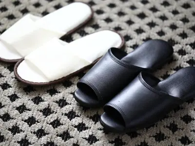 a pair of black shoes and a pair of white shoes at APA Hotel Kanda Ekihigashi in Tokyo